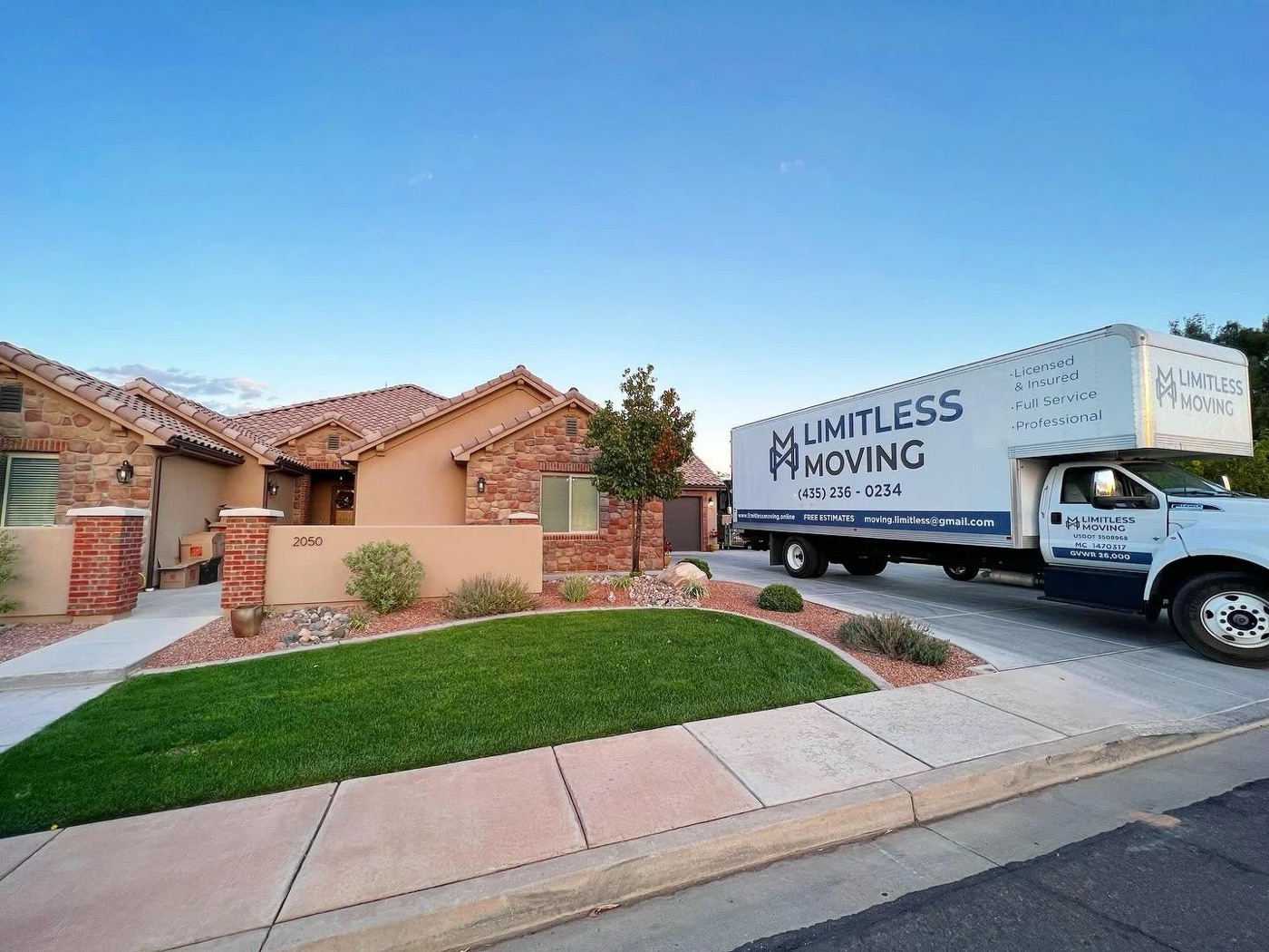 Limitless Moving truck parked at a home