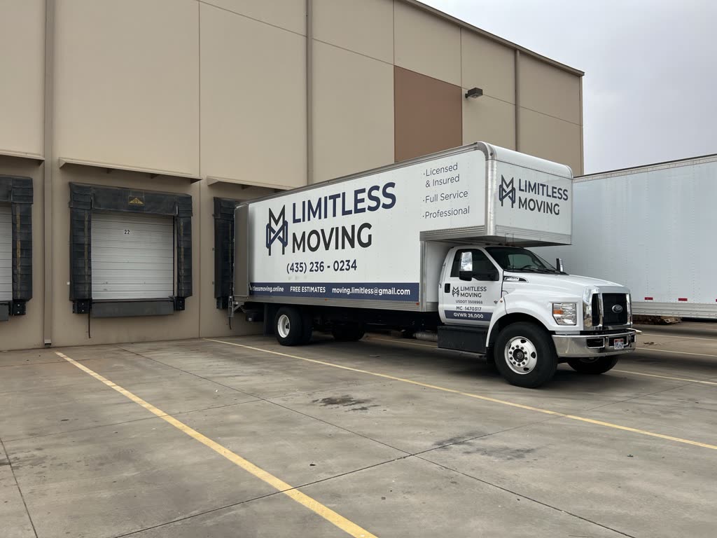 Limitless Moving truck backed up to a loading dock